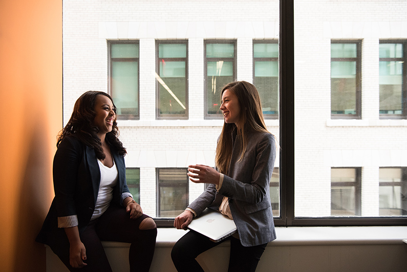 Two female students interacting in the classroom