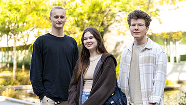 Three students outside in the university